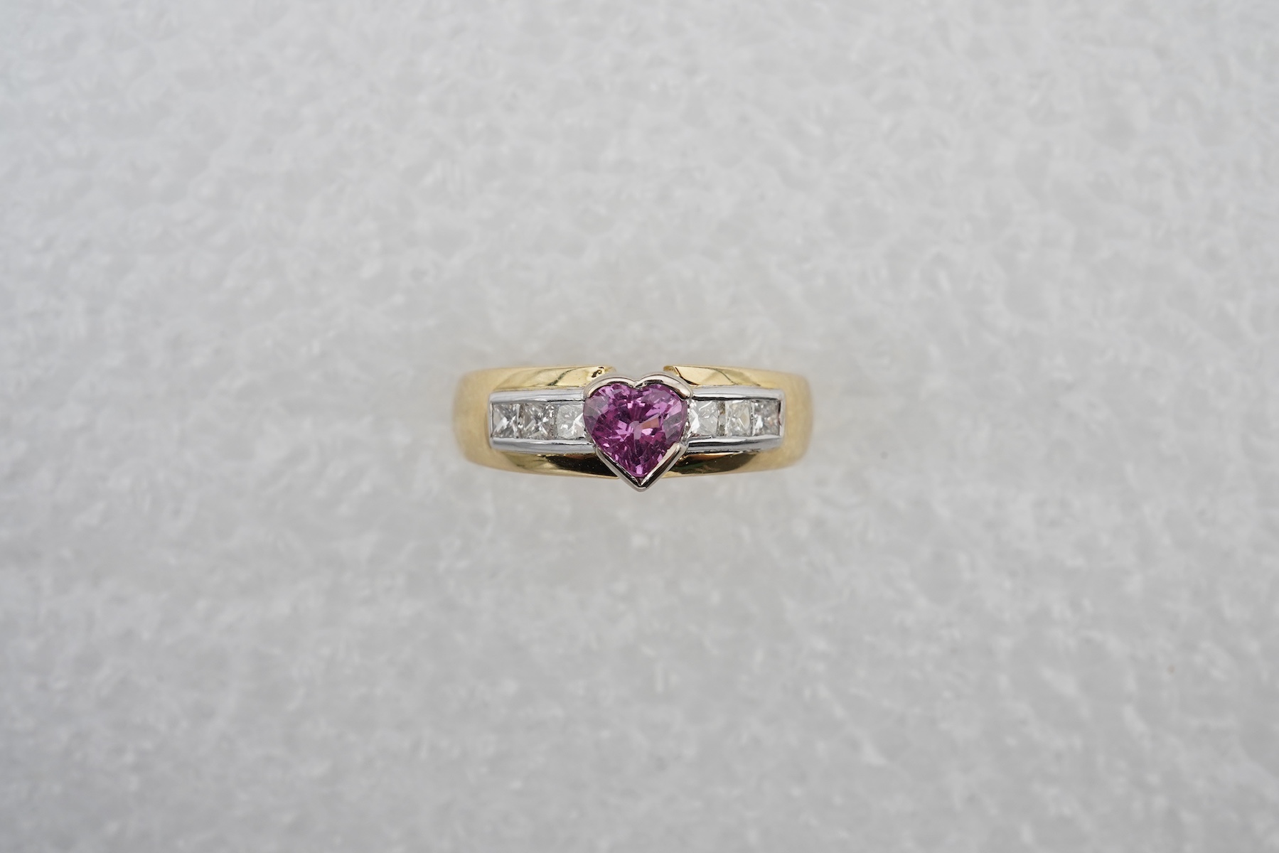 A pink sapphire and diamond ring